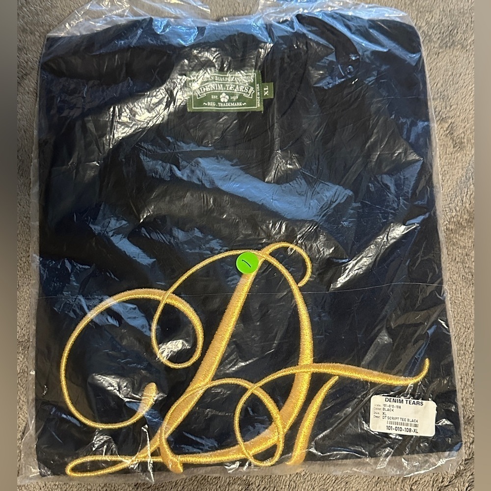 Denim Tears Black T-Shirt with Gold Lettering​
